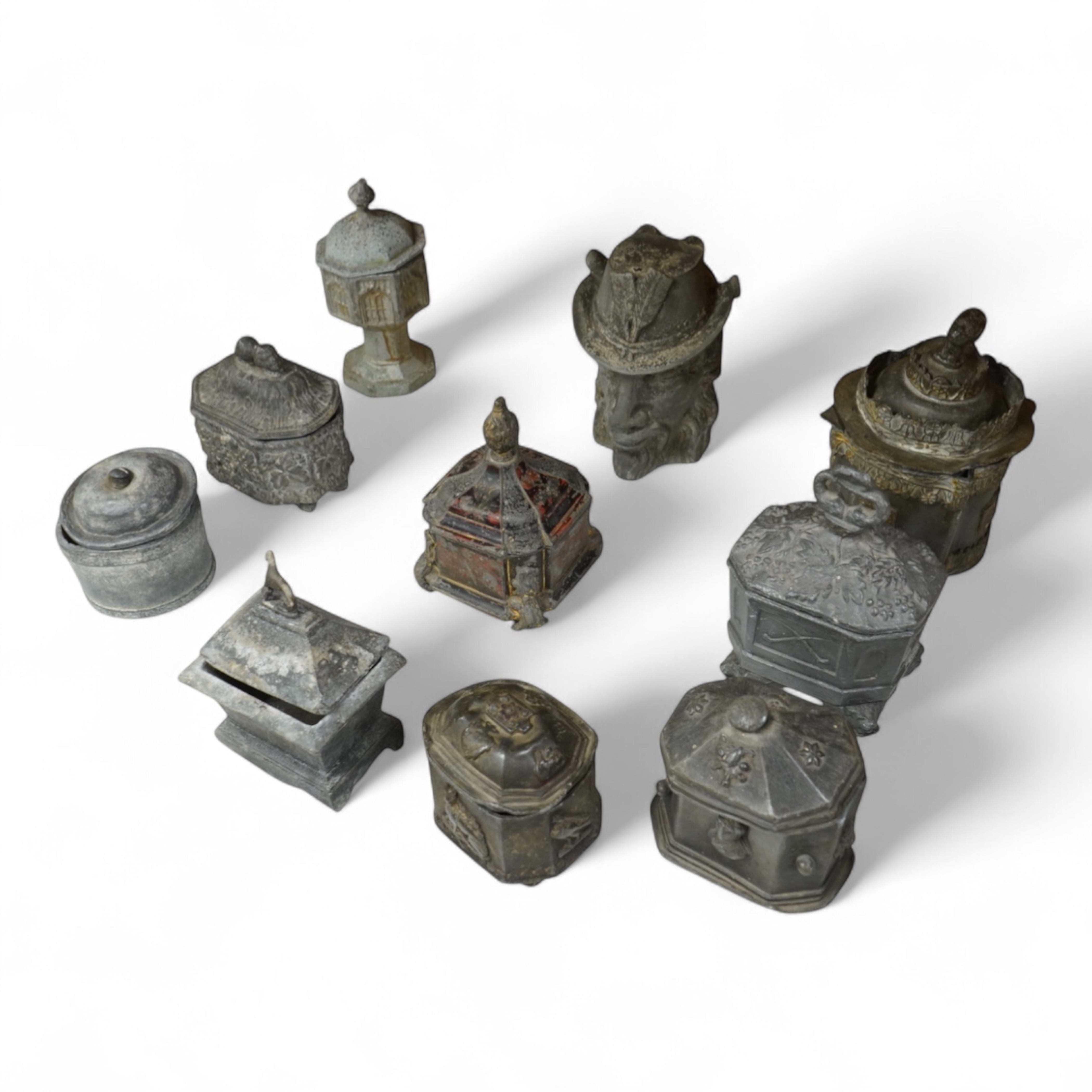 A collection of ten early 19th century lead tobacco boxes, one in the form of a goat’s head, tallest 20cm